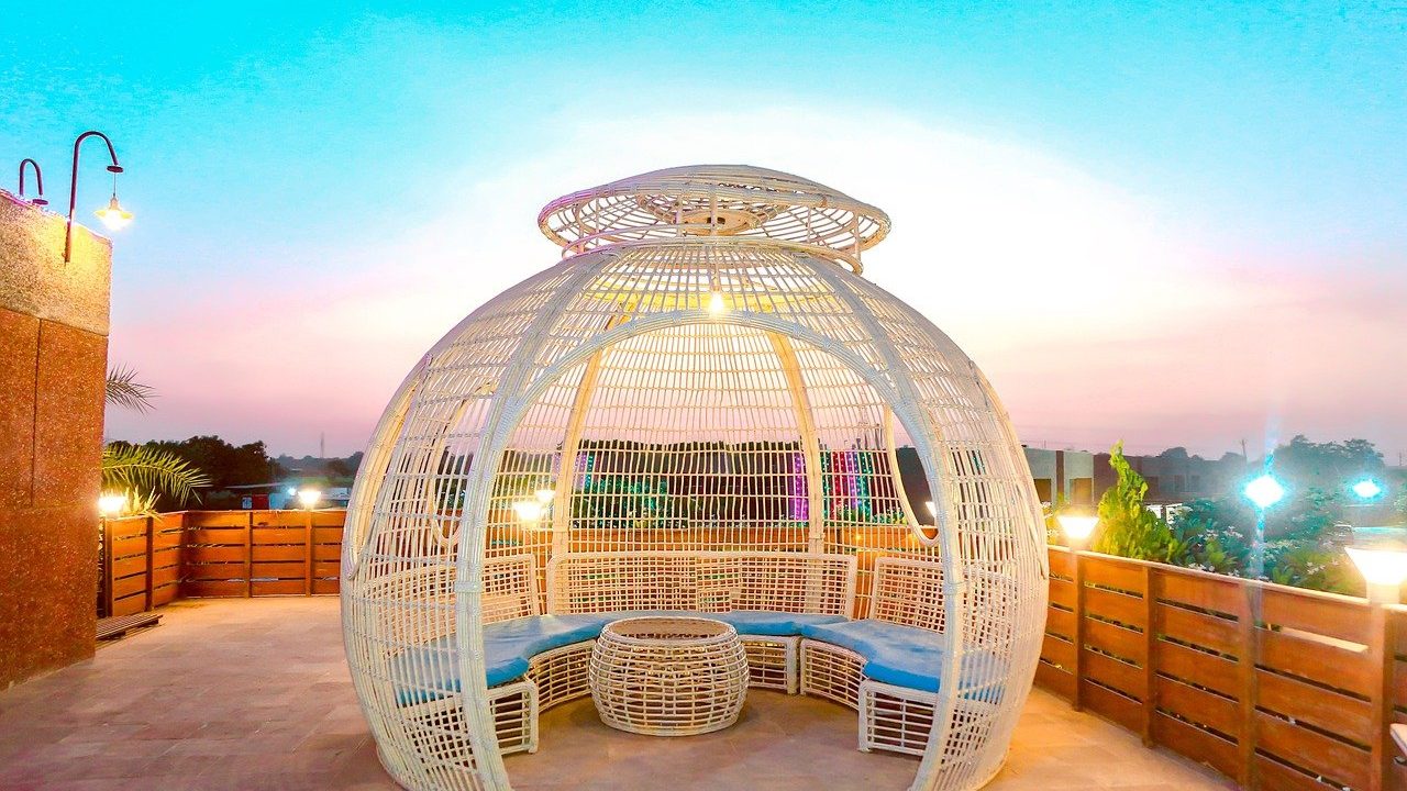 A domed garden pod beside a pool at sunset