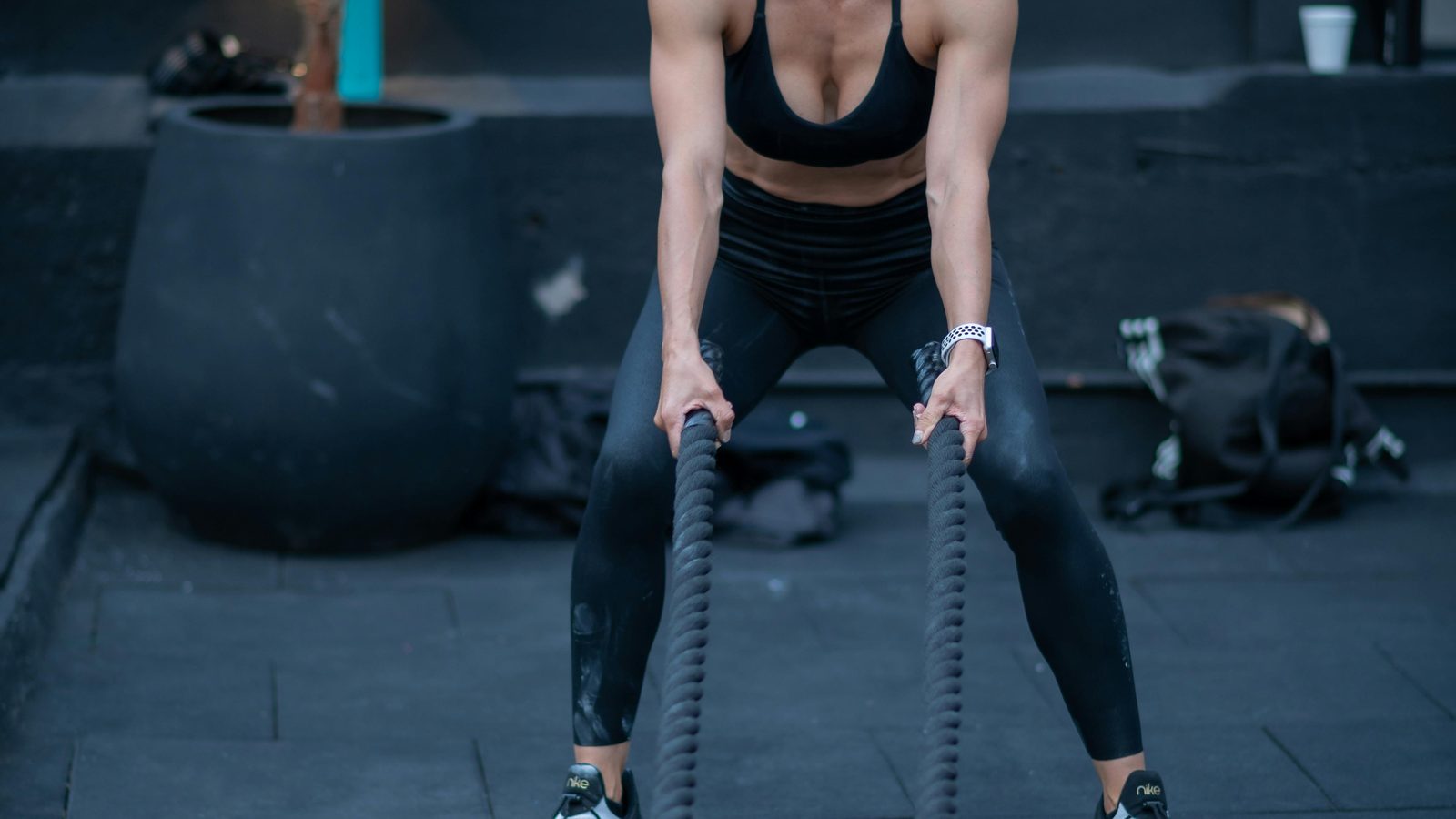 Training with battle ropes in an outdoor gym space