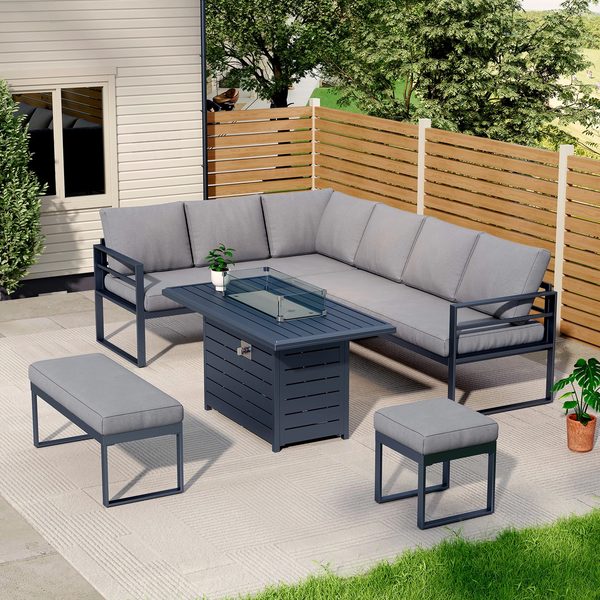 A grey outdoor sofa set with a fire pit table